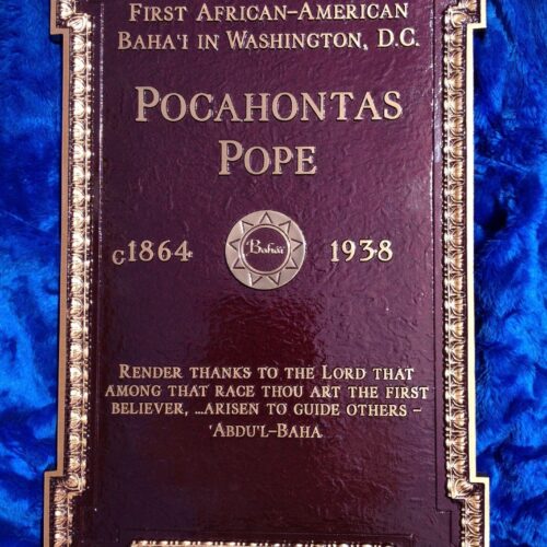 An ornate marker with a decorated gold edge reads “First African-American Baha’I in Washington, D.C. Pocahontas Pope c 1864-Bahaii-1938 Render Thanks to the Lord that Among that race thou art the first believer,...Arisen to guide others-Abdu’l-Baha”