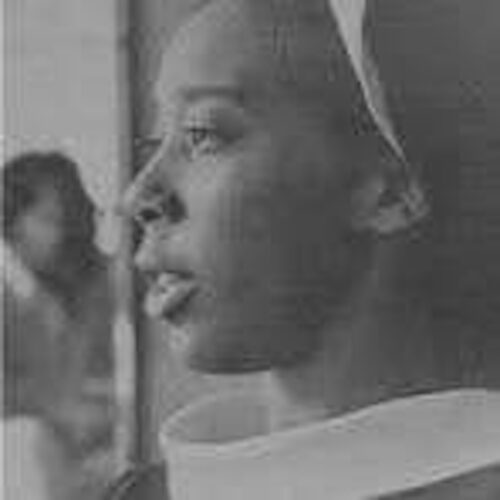 young Patricia Grey, looking left, wearing her nun's habit. The photo is in black and white.