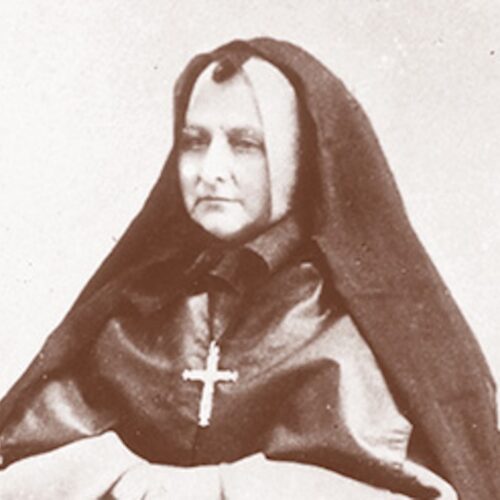 Mother Theresa Maxis Duchemin wearing nun's habit and a large cross. The photo is in sepia tones.