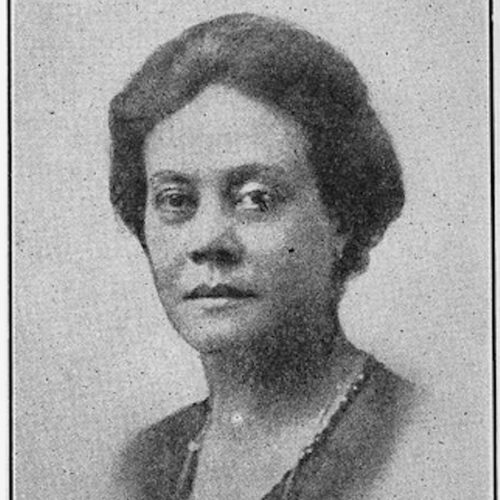 Alice Moore Dunbar-Nelson wearing her hair pulled back, with a V-necked top and a necklace. The photo is in black and white.