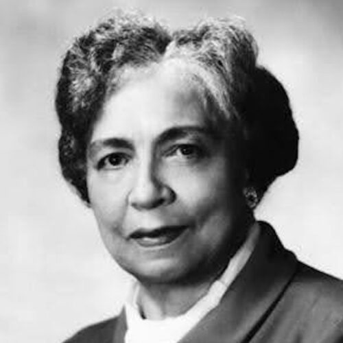 Dorothy Boulding Ferebee wearing short hair parted slightly to one side with waves, a white top under a collared jacket.