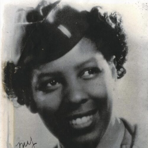 Fannie Griffin McClendon smiling, wearing short hair, her army uniform and cap. The photo is in black and white.